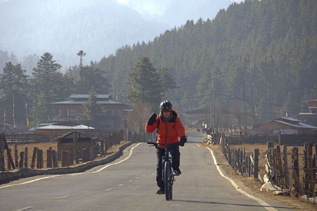 Russian guest cycling through Bumthang Valley in Central Bhutan