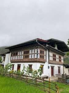 Traditional Bhutanese homestay surrounded by mountains